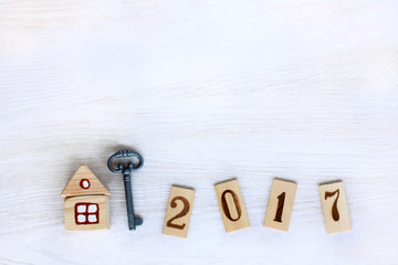 individual housing in 2017/ Concept finished house with a key, and digits on wooden plates denoting year 