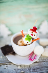 Marshmallow snowman in hot chocolate. Winter sweet delicious.