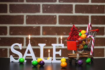 Trolley for products on a brick wall background New Year's sale