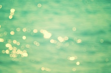 Blur tropical beach with bokeh sun light wave abstract background.