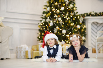 Fototapeta na wymiar Christmas Eve. Children write letters to Santa Claus.