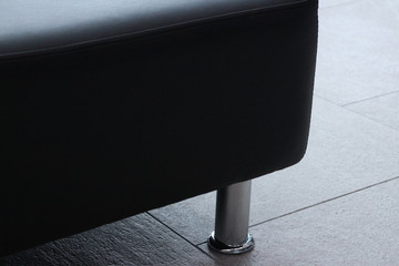 massive leather sofa with chrome leg close to