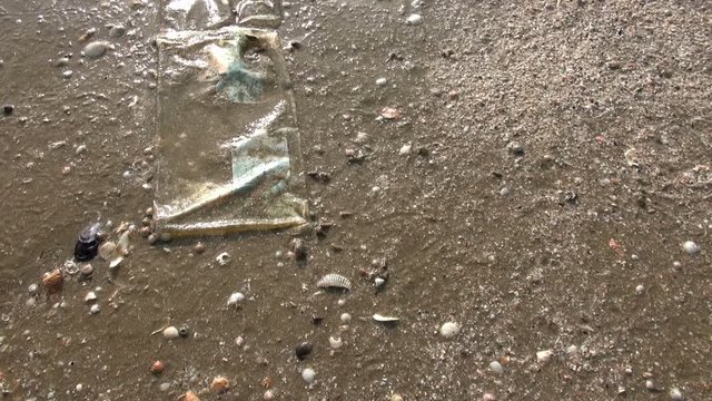 Rubbish On The Beach. Tiny crabs pick food from the sand surrounding a discarded plastic bag. At 10 seconds we zoom in to almost macro to examine the crustations and crabs.