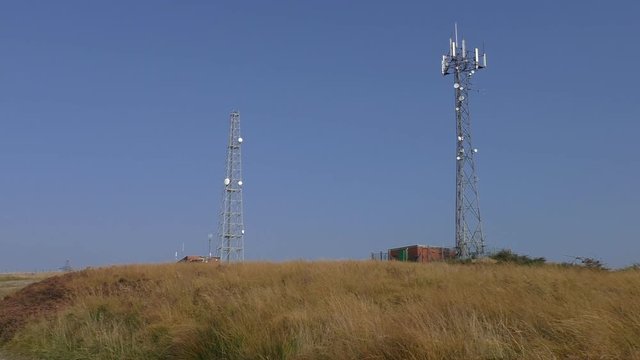 Telecommunications tower and service building on Crompton Moor near Oldham, England, UK