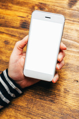 Businesswoman looking at blank screen of white smartphone in off