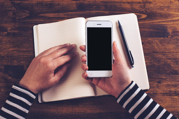 Top view mockup of business woman hands using smartphone