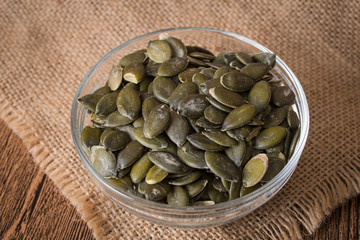 Pumpkin seeds on rustic background
