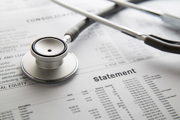 Stethoscope on the document. Financial concept