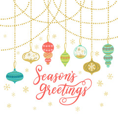 Season's Greetings greeting card. Vector winter holiday background with hand lettering calligraphy, confetti, balls, garland elements.