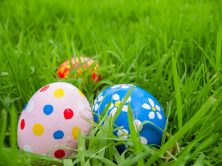 Hand painted Easter eggs hidden on the grass ready for the easter egg hunt traditional play game