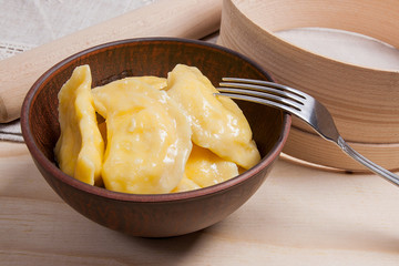 Fresh boiled varenyky or dumpling with cottage cheese or curd in