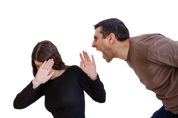 Domestic violence scene with a abusing husband or boyfriend shouting and yelling at his wife or...