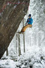 Unique winter sports. Rock climber on a challenging ascent. Extreeme climbing. 