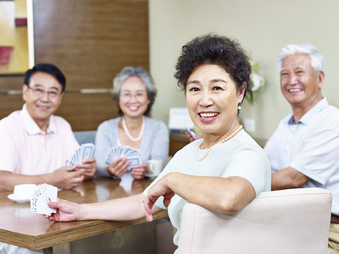 senior asian woman in  card game