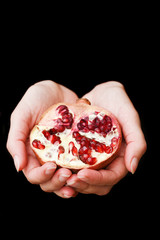 Healthy food. Fruit of grenades in the girl's hands.