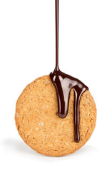 on cookies pouring stream of chocolate on a white background