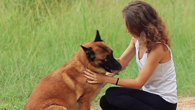 girl playing with a german shepherd in slow motion