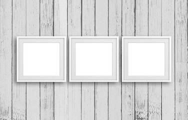 Three blank frames on old white painted vertical panels  background,  decor mock up	