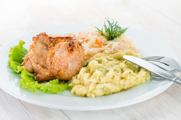Russian homemade dish: mashed potatoes, chicken and cabbage sala