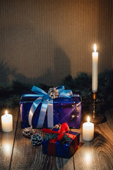 New Year composition View from above. Herringbone toys with candles, boxes on wooden background