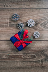 Gift box and a cone on  Christmas background