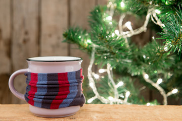 Ginger tea in a cup on wooden background