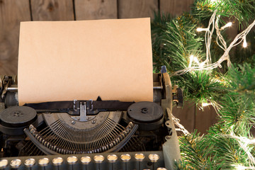 Fototapeta na wymiar Christmas concept - Typewriter with the blank paper and lights
