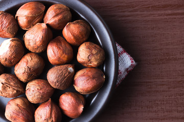 Hazelnuts on a plate with old kitchen dishcloth.