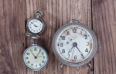vintage watches, old alarm clock on a wooden background