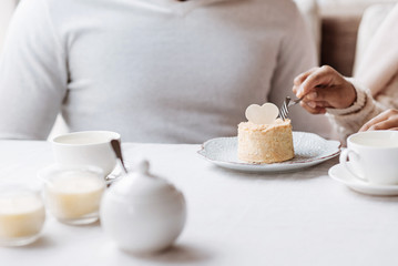 Peaceful African American couple eating the cupcake in the cafe