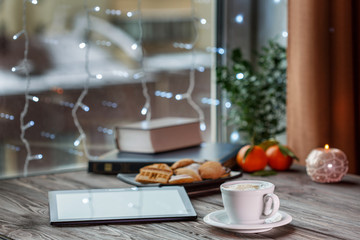 A cup of hot coffee on wooden table in cafe, close up view