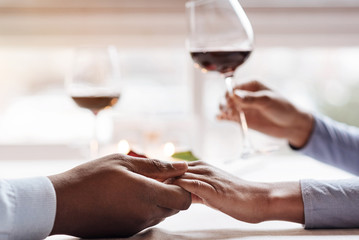 Young African American couple having the date in the restaurant