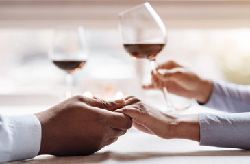 Positive African American couple enjoying the beverage in the restaurant