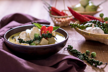 Chicken mussaman curry in bowl vegetables on wooden background