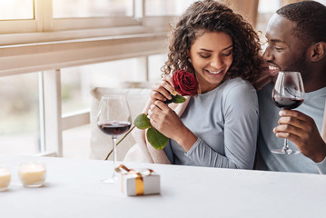Positive African American couple hugging in the restaurant