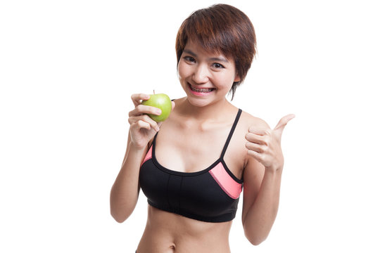 Beautiful Asian healthy girl thumbs up with apple.