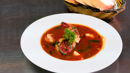 Seafood soup in white plate