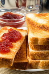 Toasted slices of bread with strawberry jam close-up