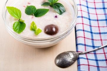 View close-up on a healthy dish of oatmeal in a bowl of glass