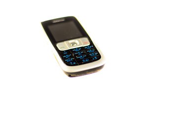 Old cell phone isolated on white