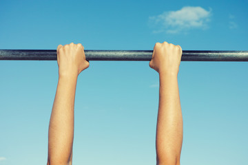 Person hanging on horizontal bar