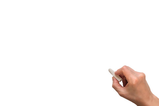 Hand holding white chalk and starting to write