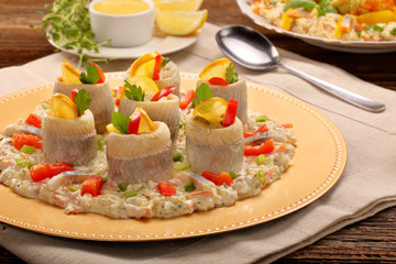 Rolled herrings with fish salad and lemon