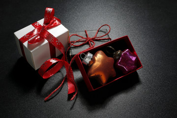 christmas gifts with colorful baubles on black background