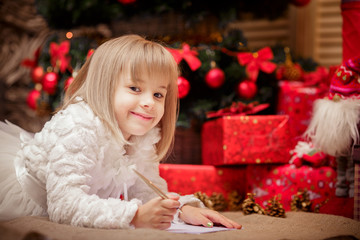 little girl writes a letter to Santa Claus
