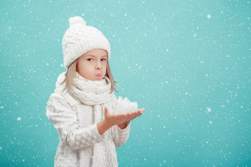 little blonde girl in a white hat and scarf 