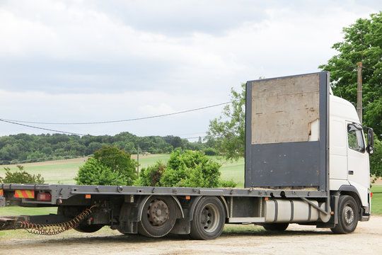 a flatbed truckin country waiting for transportation of straw or other farm production