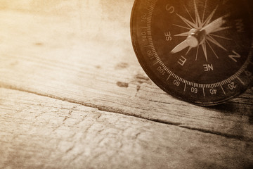compass on wooden table in vintage style for background

