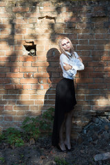 An outdoor fashion gothic style portrait of a beautiful blonde girl