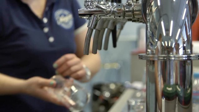 Barman pulling a pint of beer behind the bar